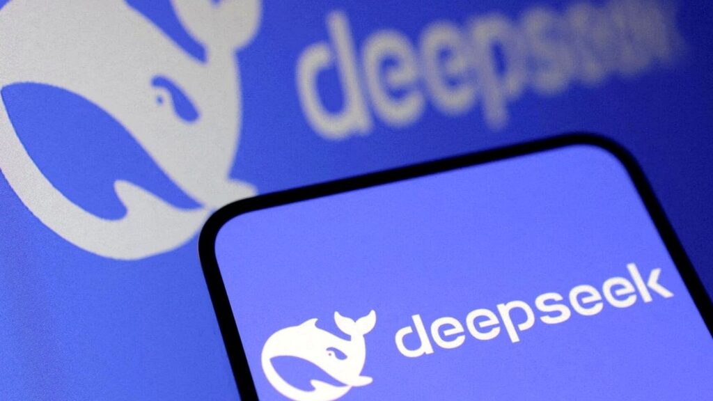 スマートフォンの画面にdeepseekのロゴと白いクジラのアイコンが表示されており、背後のぼやけた背景にもdeepseekのテキストとロゴが見える。